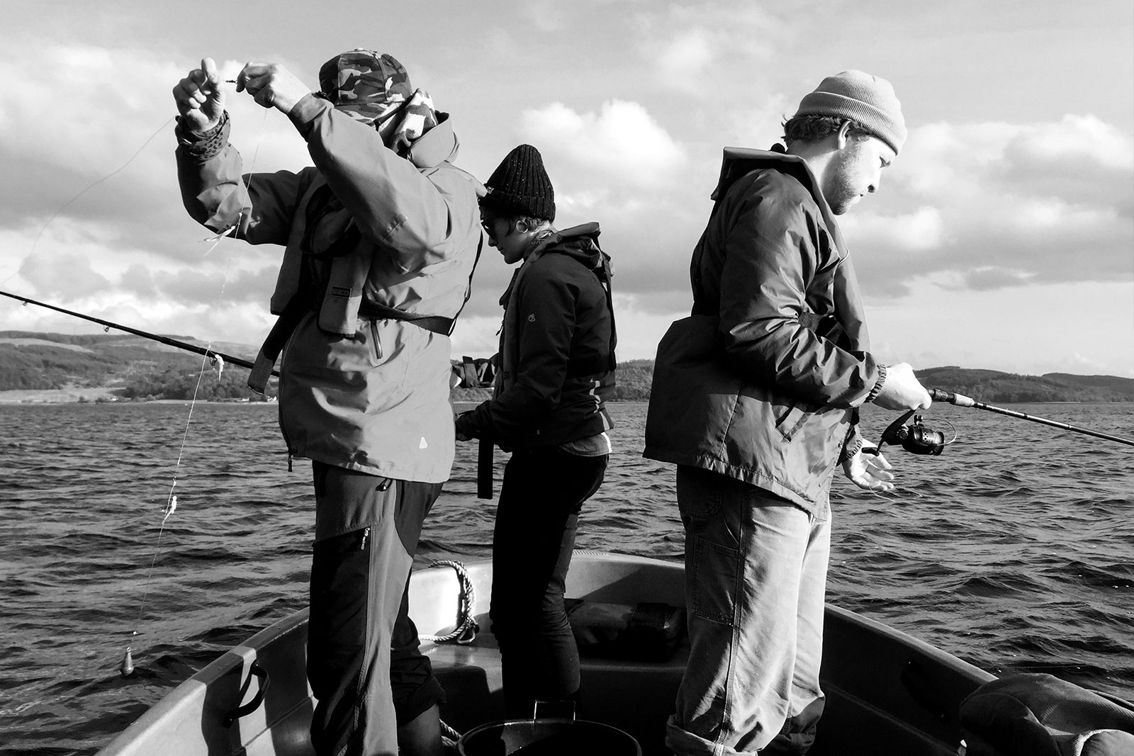 O Street's annual fishing trip 2019, Directors Neil Wallace and Tessa Simpson and Design Jonny Mowat fishing from a boat on Loch Fyne.