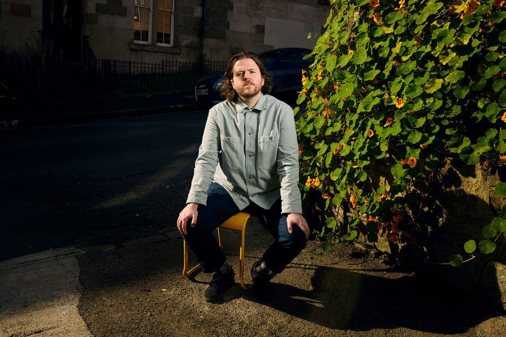 O Street designer Andrew Johnston yellow chair portrait by Peter Dibdin